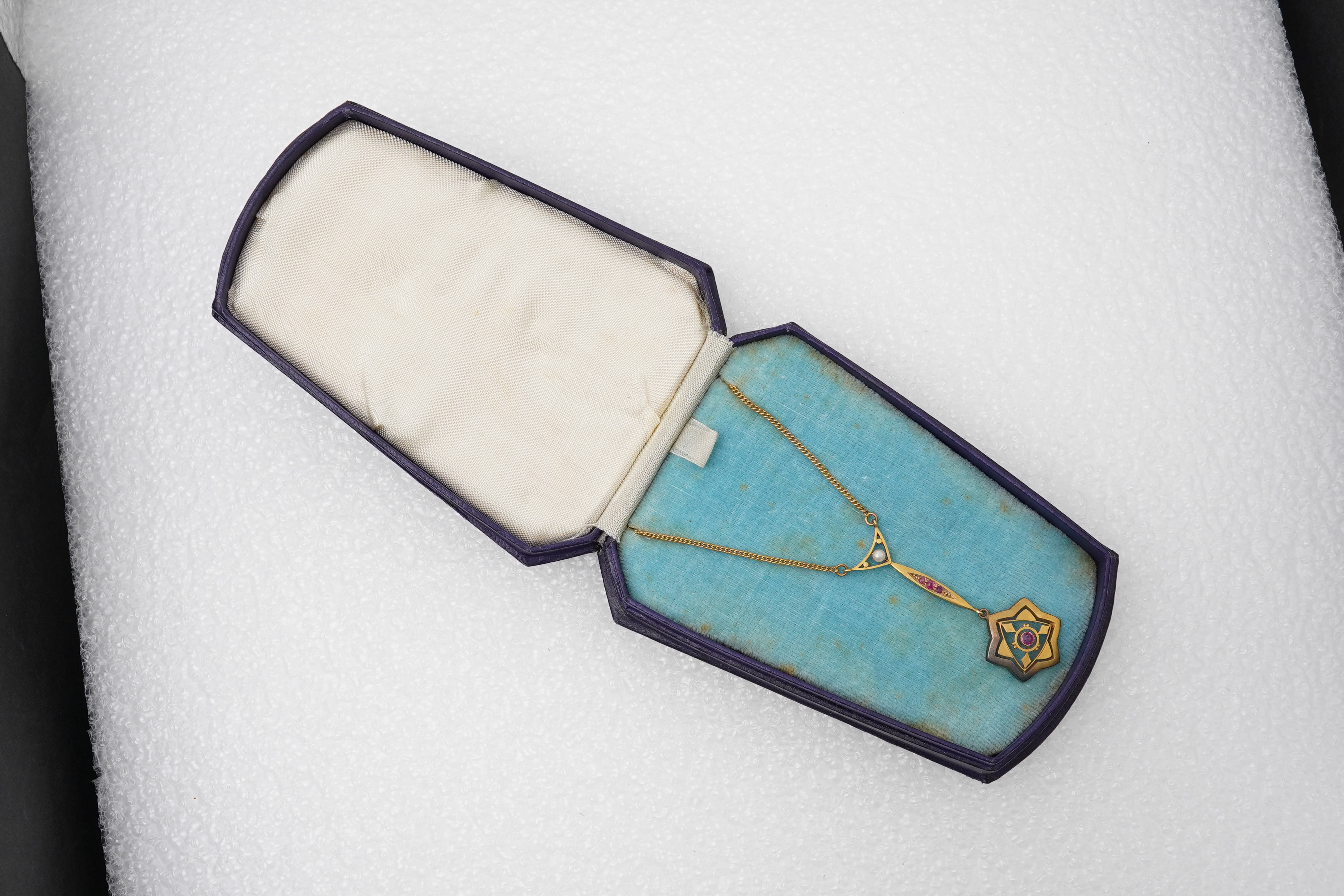 A gold, ruby and seed pearl pendant necklace, early 20th century